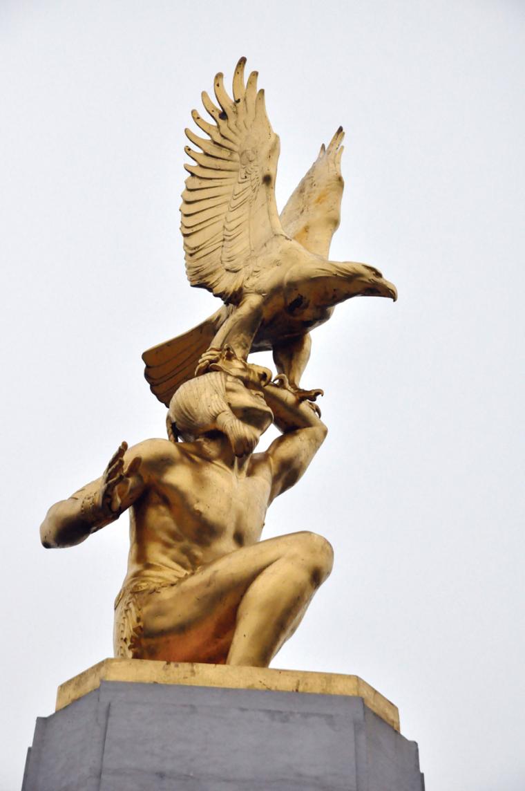 A close-up of an American Indian holding an eagle sits atop Tours American Monument.