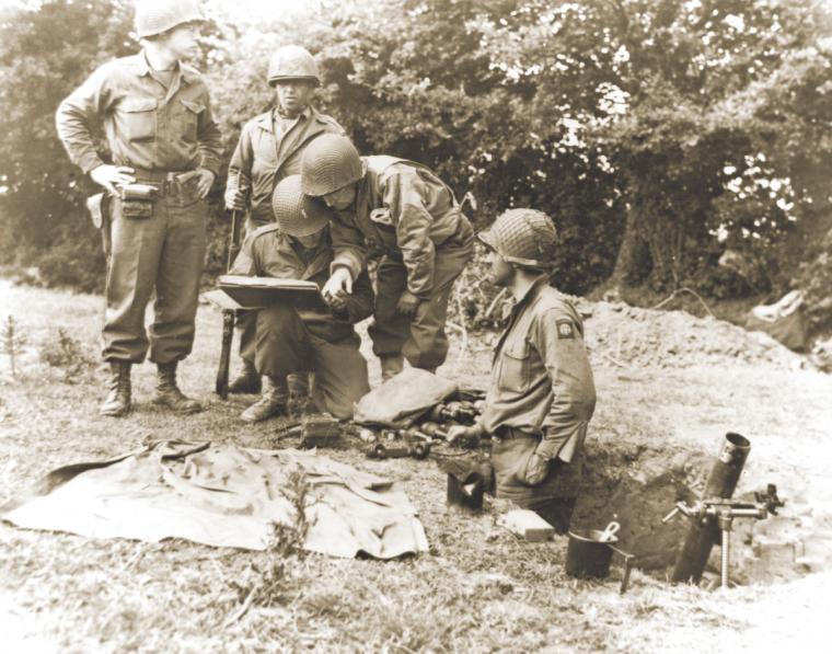 Colonel confers with an 81mm mortar crew, June 8, 1944.