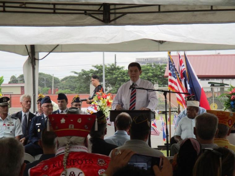 A man delivers remarks from a podium. 