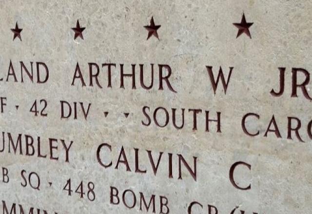 A bronze rosette is placed next to the name of Arthur W. Crossland