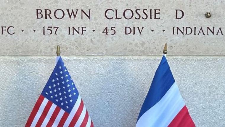 A bronze rosette is placed next to the name of Pfc. Clossie D. Brown at Epinal American Cemetery